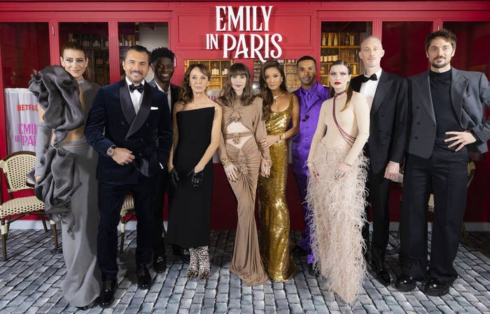 The cast of Emily in Paris pose for a group photo