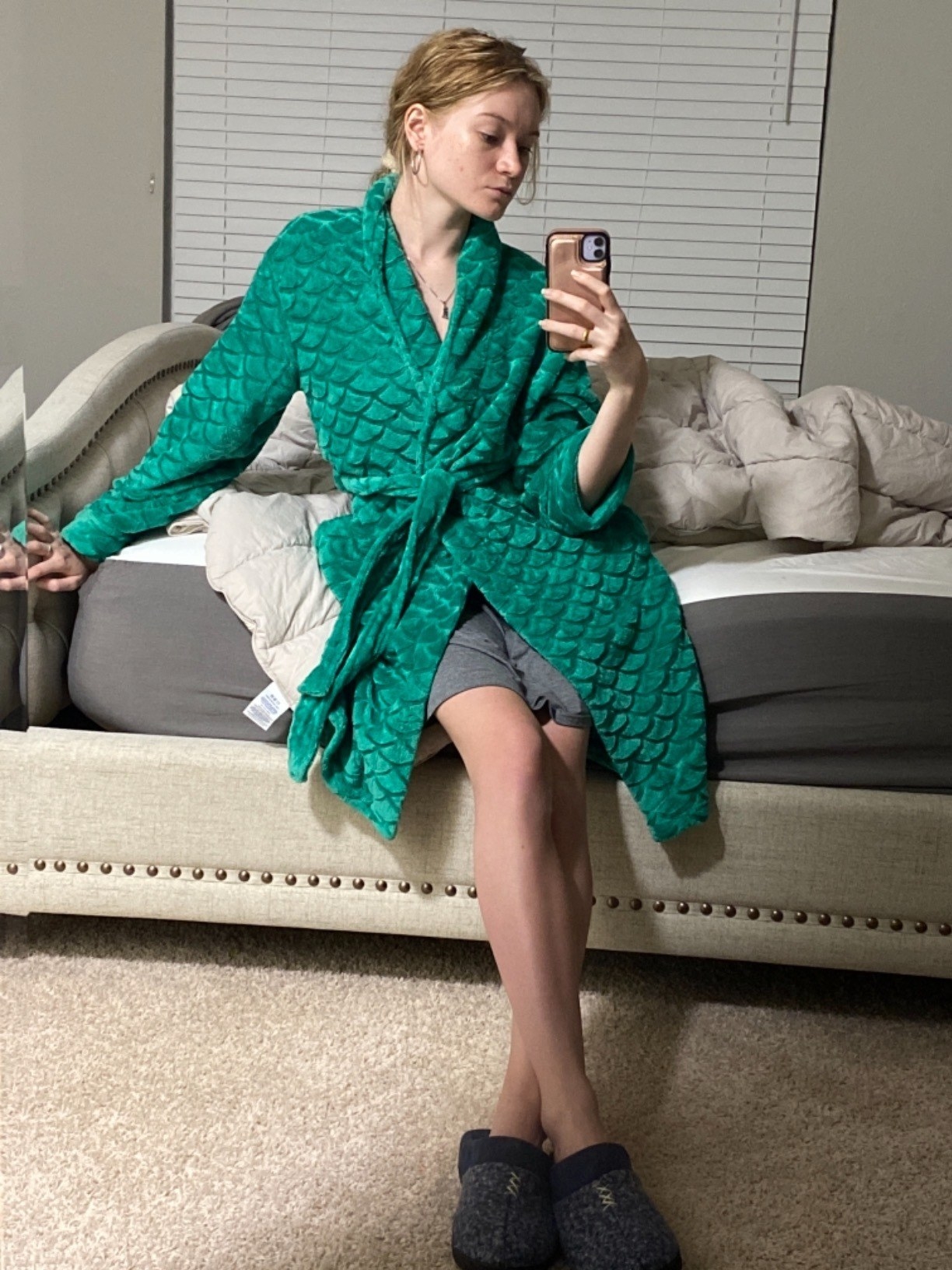a reviewer wearing the robe in green