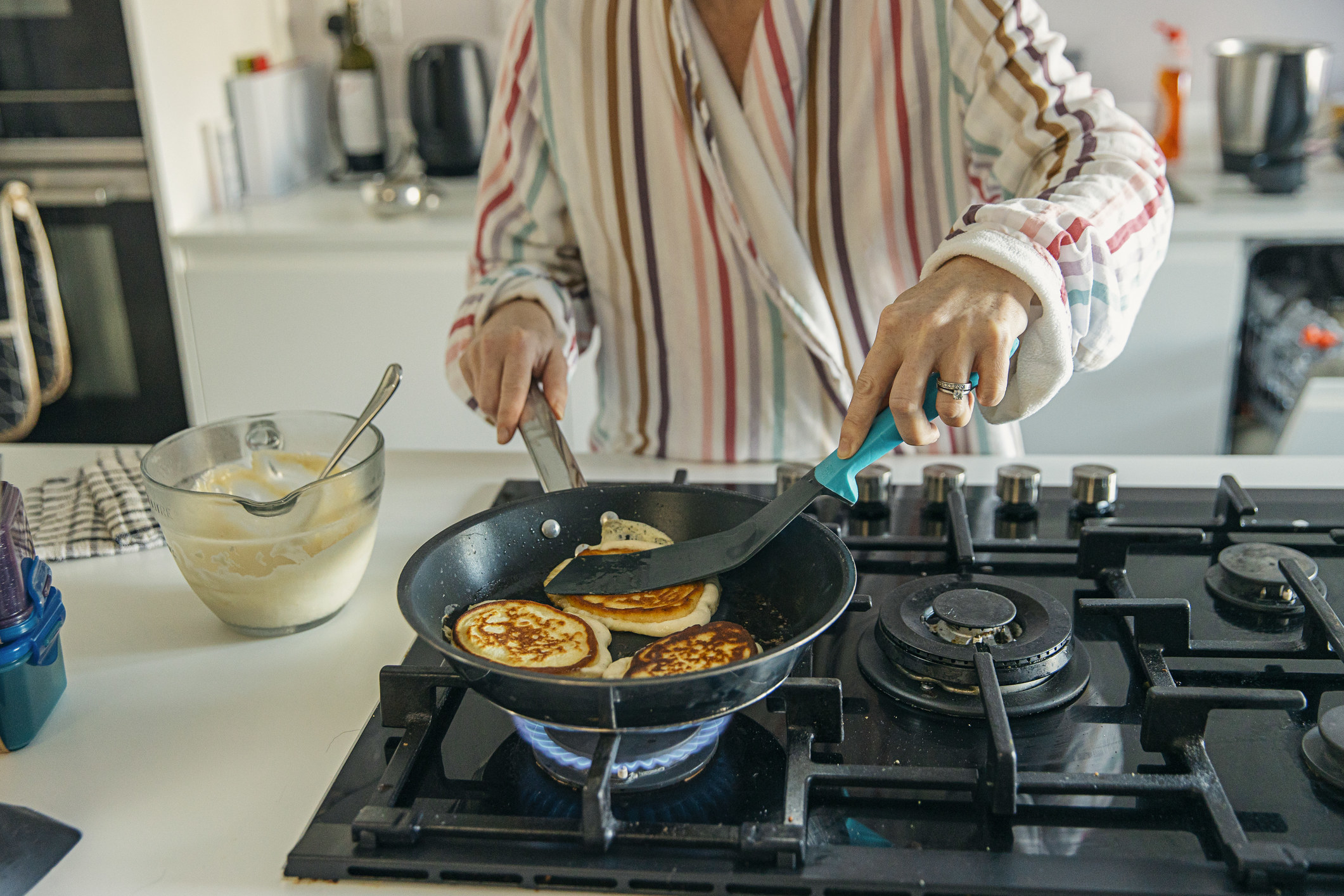 Woman cooking pancakes on the stove