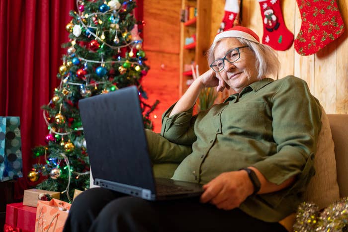A woman on her laptop wearing a Santa Claus hat