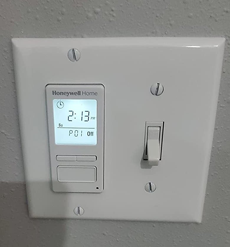 reviewer&#x27;s light switch panel with one traditional switch and one programmable switch