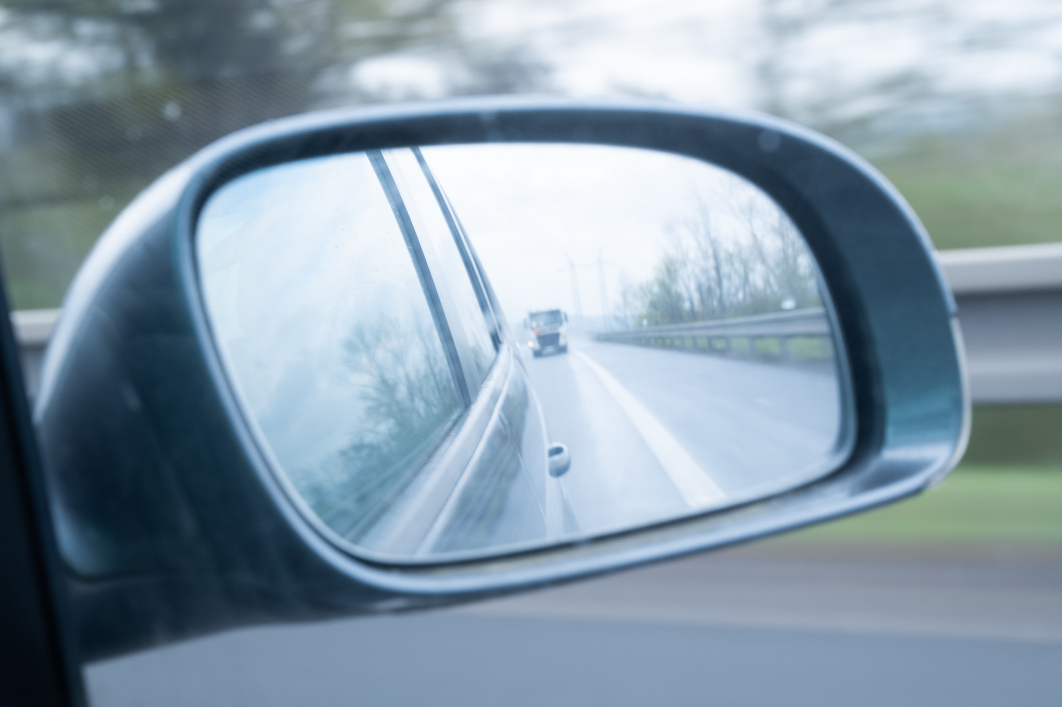 A car in the rear view mirror