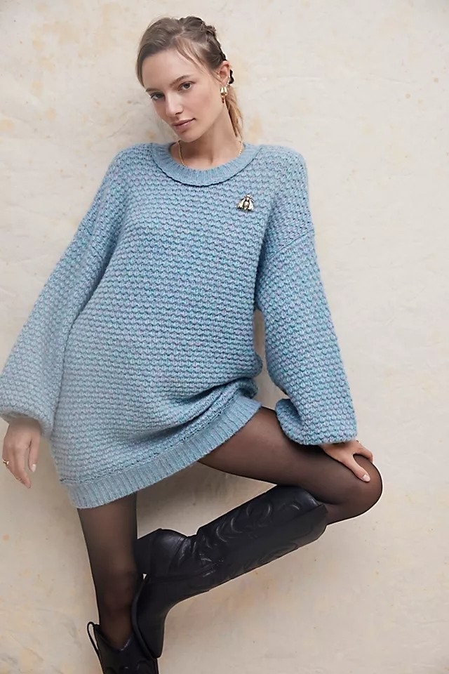 Model wearing blue cable knit mini sweater dress