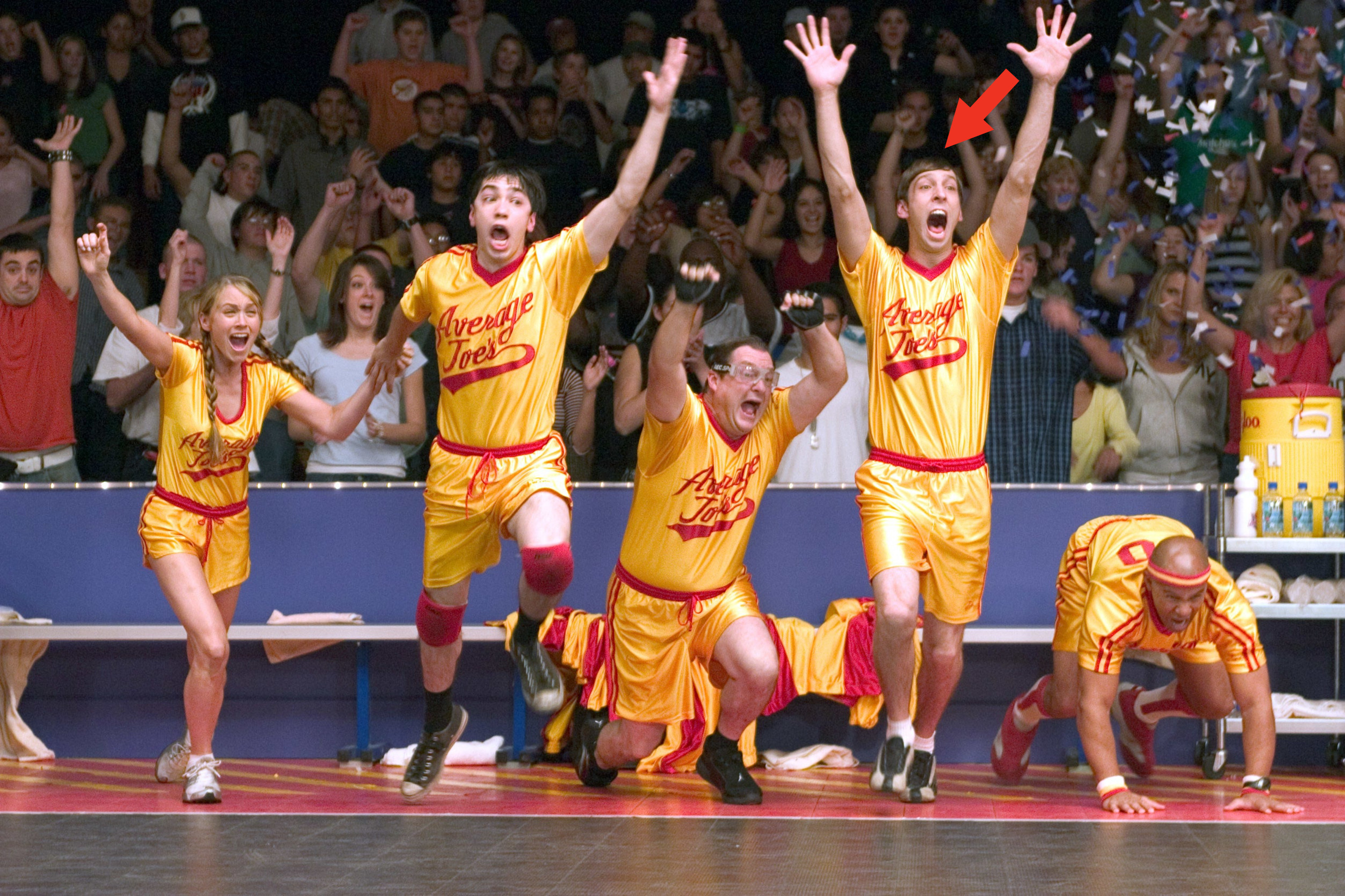 Christine Taylor, Justin Long, Stephen Root, Joel Moore with a red arrow pointing at him and Chris Williams in Dodgeball: A True Underdog Story