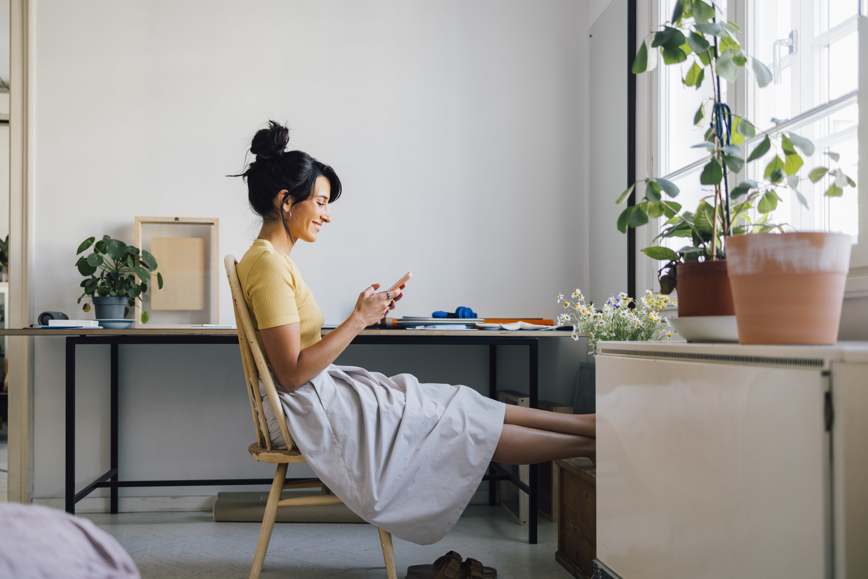 Woman puts up her feet in her apartment