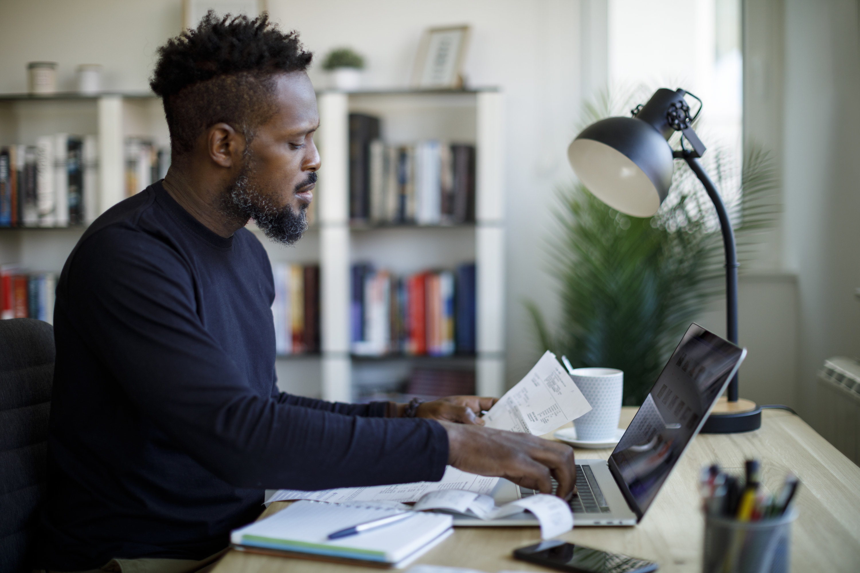 Man looking at papers at his desk