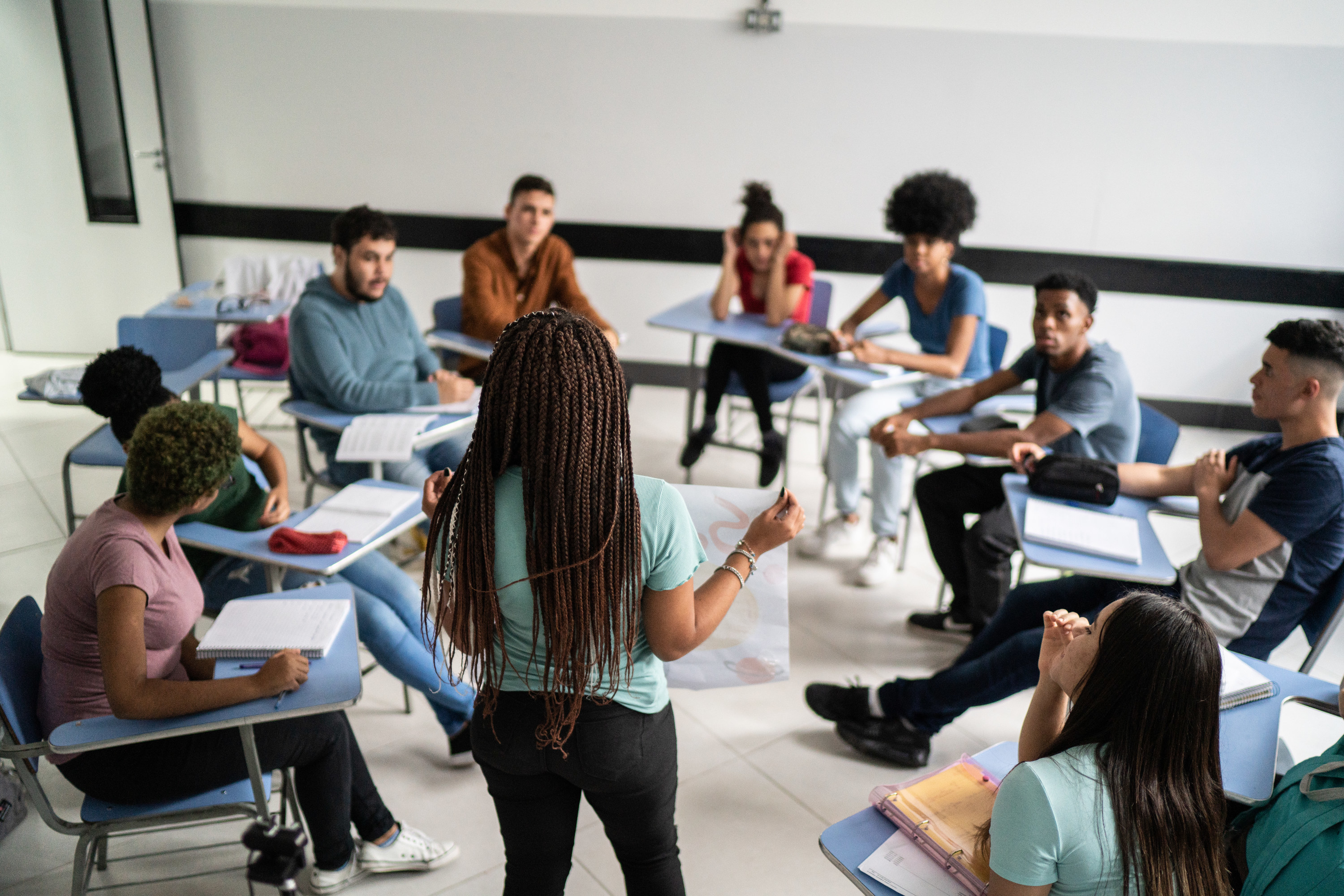 Woman teaching a small group of young people