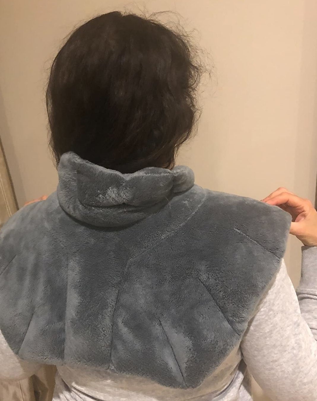 Reviewer wearing neck heating pad