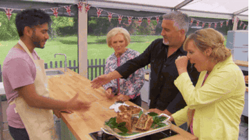 paul hollywood and mary berry shaking a bakers hand