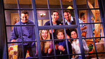 all six friends from the show friends clapping while looking out a window