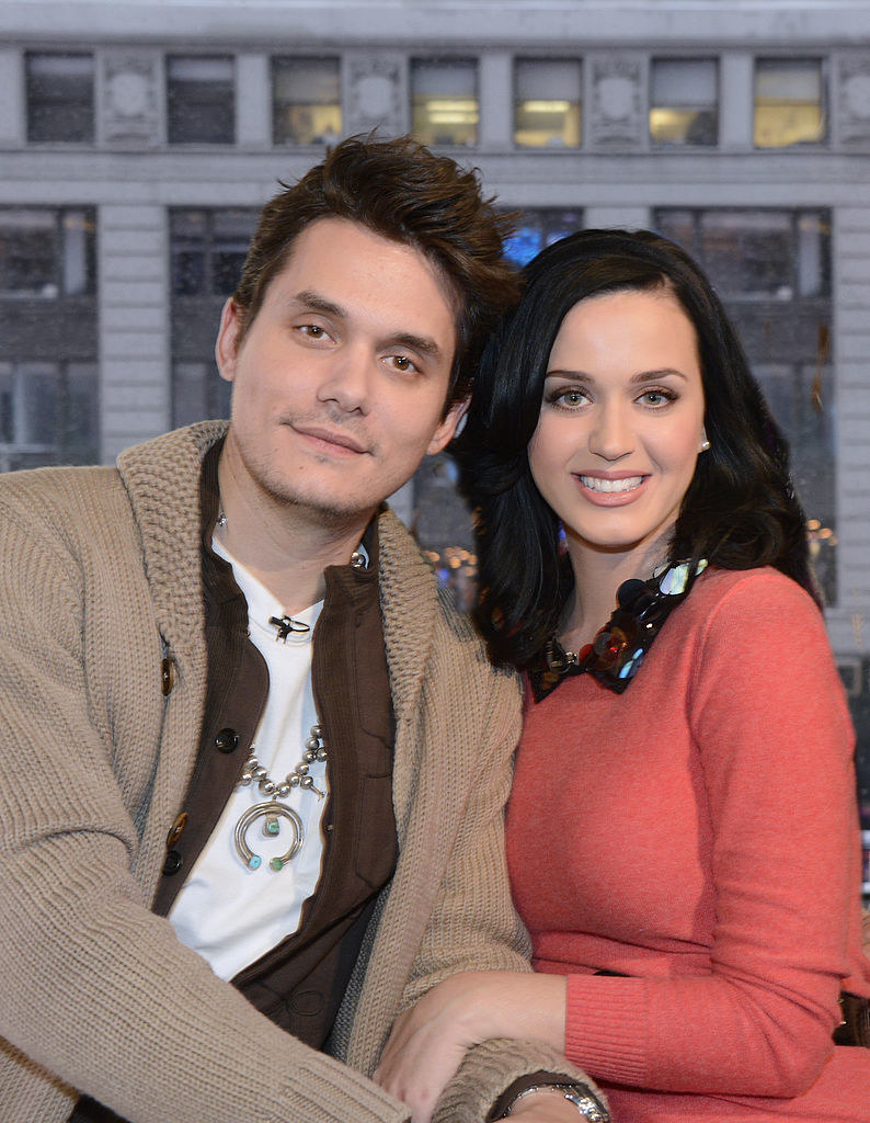 Katy holding John&#x27;s arm as they sit together