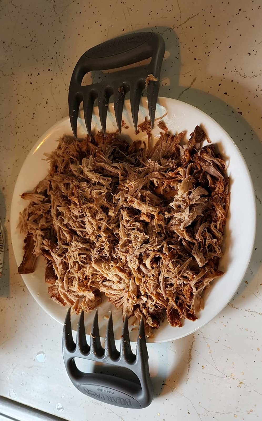 Reviewer image of a plate of shredded meat and claws next to it