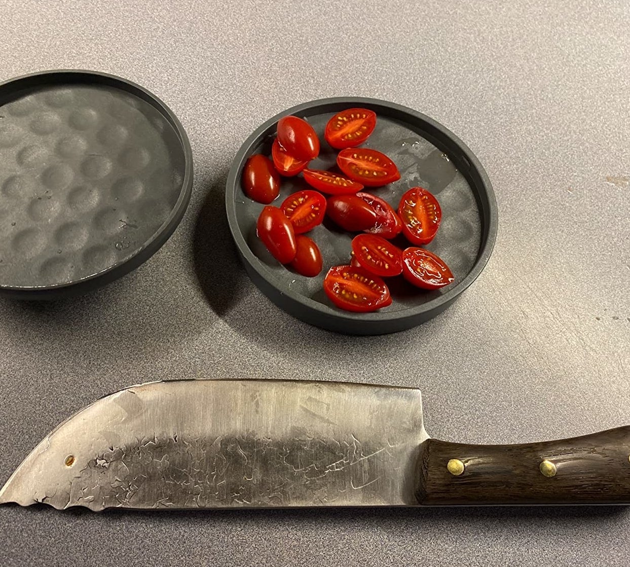 Reviewer image of slicing tool with tomatoes in it and a knife next to it