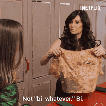 women talking while folding clothes and one says, not bi-whatever. bi. own it