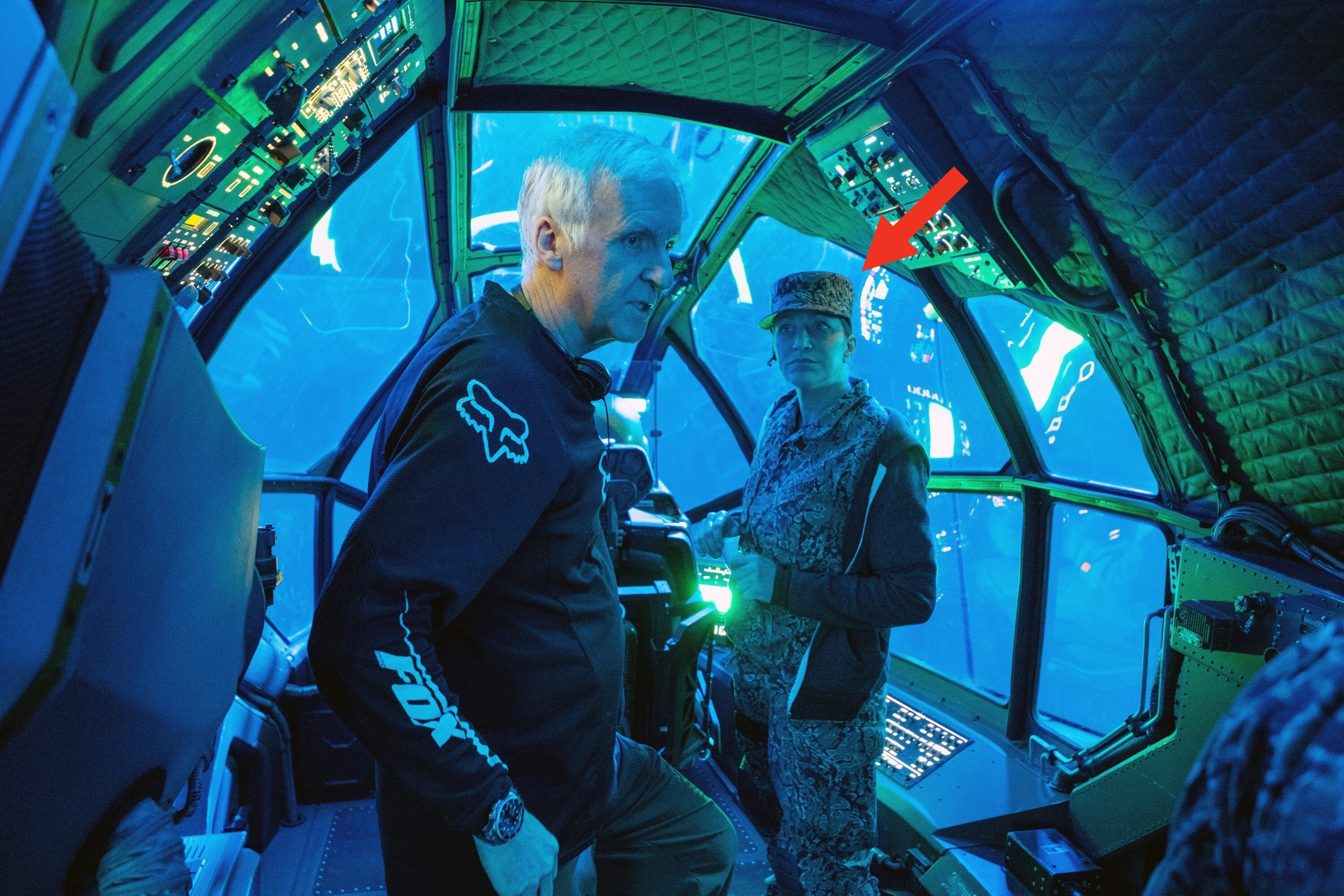 James Cameron and Edie Falco with a red arrow pointing at her on set