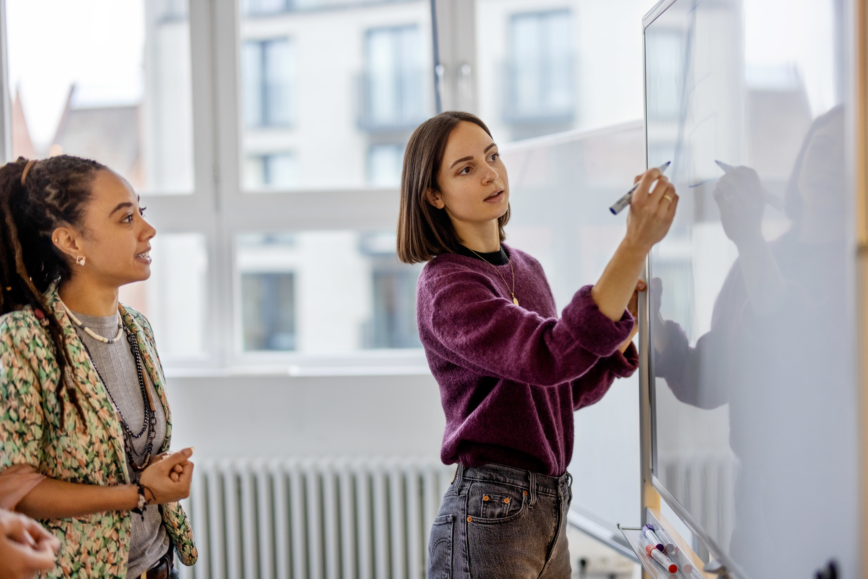 colleagues writing on a whiteboard