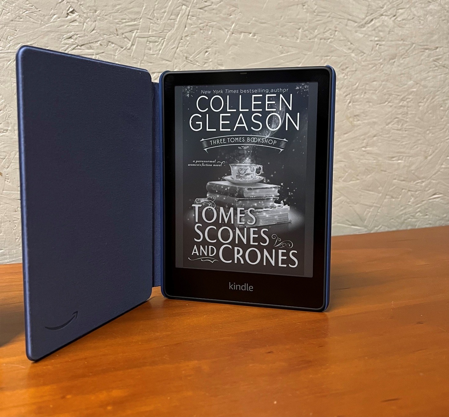 reviewer&#x27;s signature kindle open in blue case to the book &quot;Tomes Scones and Crones&quot;