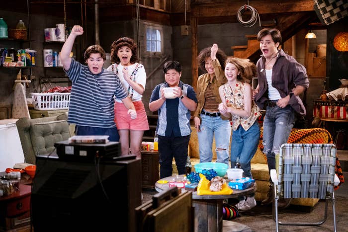 Cast of That &#x27;90s Show jumping for joy in the basement in a scene from the new series