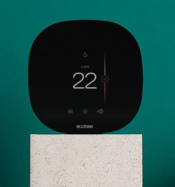 A smart thermostat perched on a standing surface