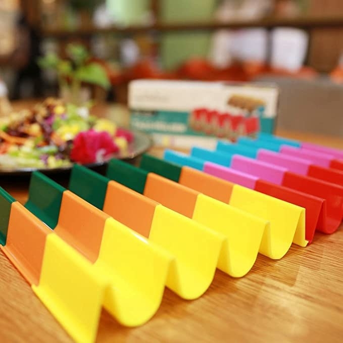 a bunch of the different coloured stands beside each other on a table