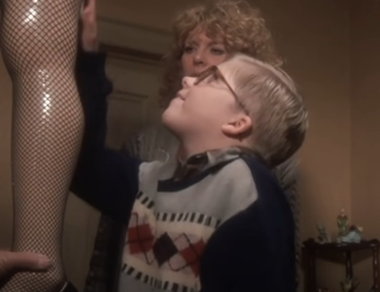 Peter Billingsley as Ralphie caressing the Leg Lamp in front of his mother