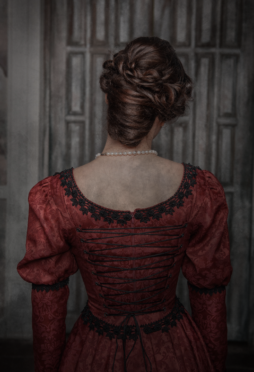 the back of a woman in a 14th-century dress with her hair up