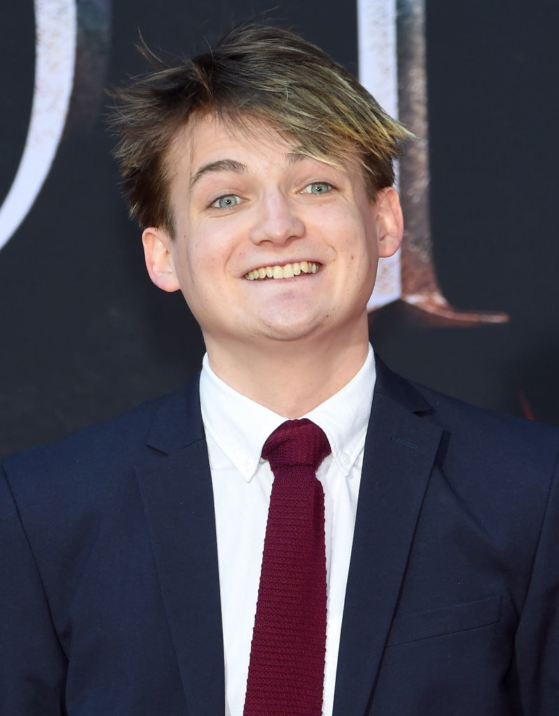 Jack Gleeson in a suit and tie and smiling