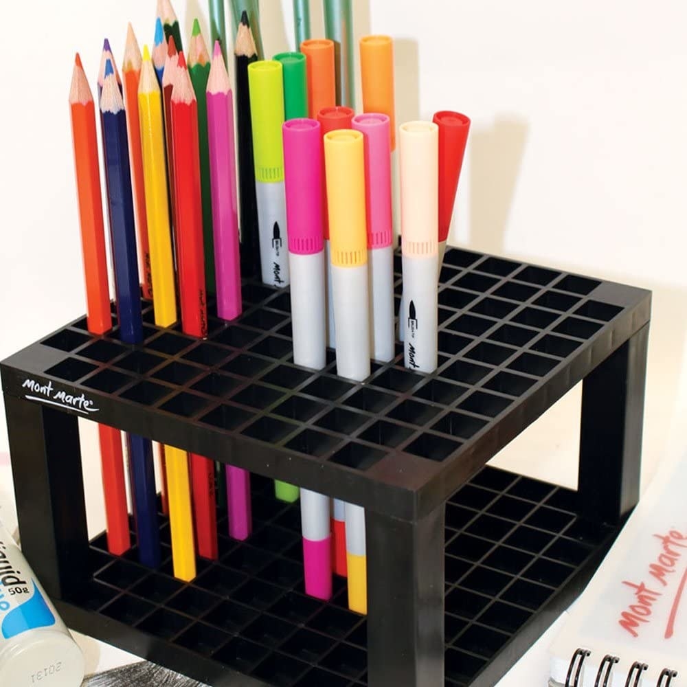 the art supply organizer filled with pens and markers