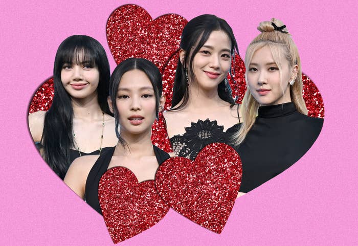 The four members of Blackpink surrounded by sparkling hearts against a pink background