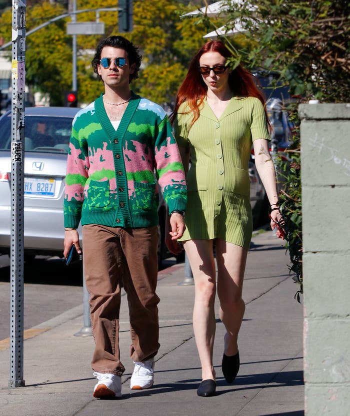 Joe and a pregnant Sophie walking on the street