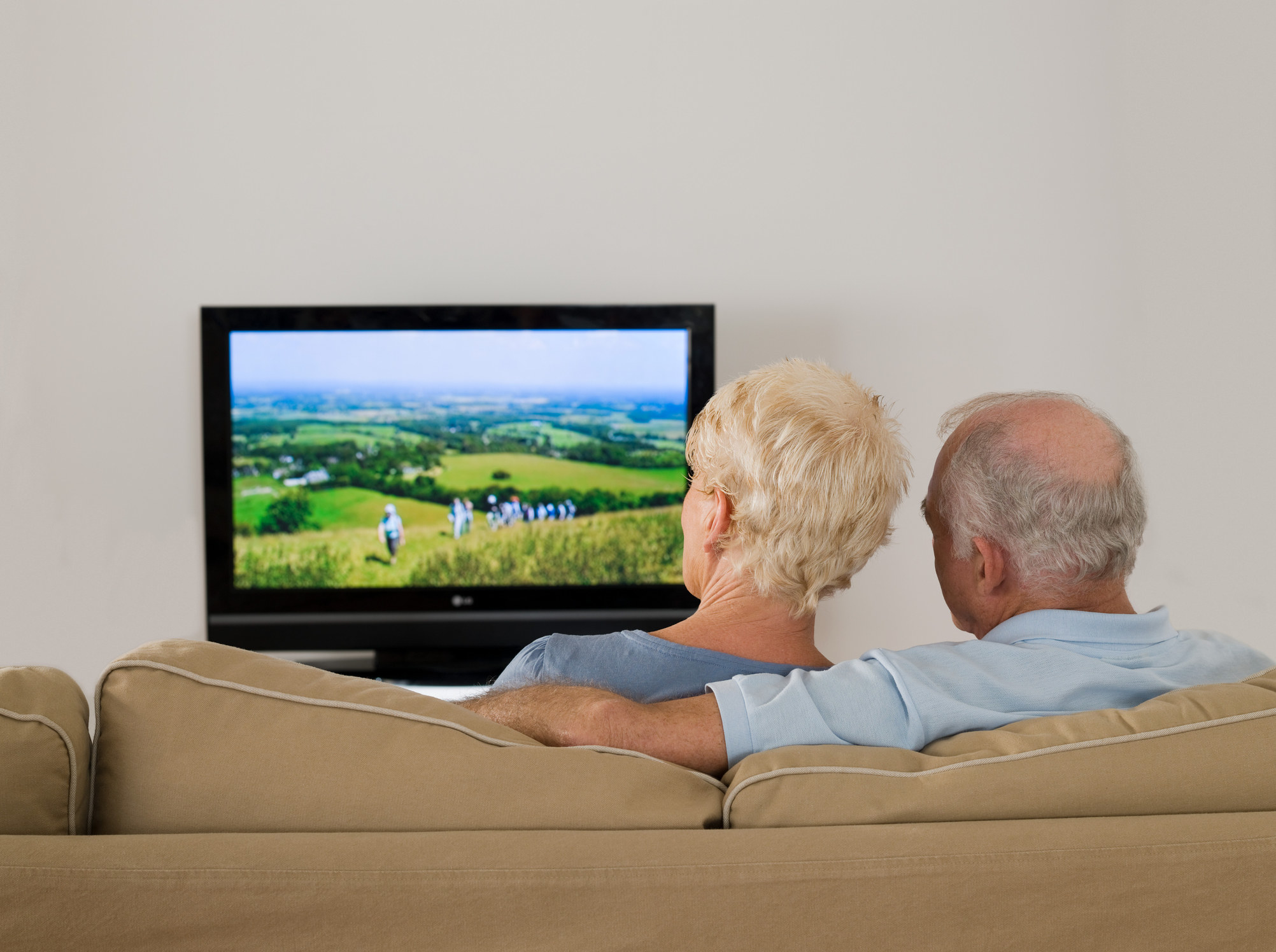 An older couple watching TV