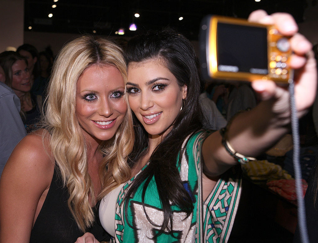 Kim Kardashian taking a selfie with a friend