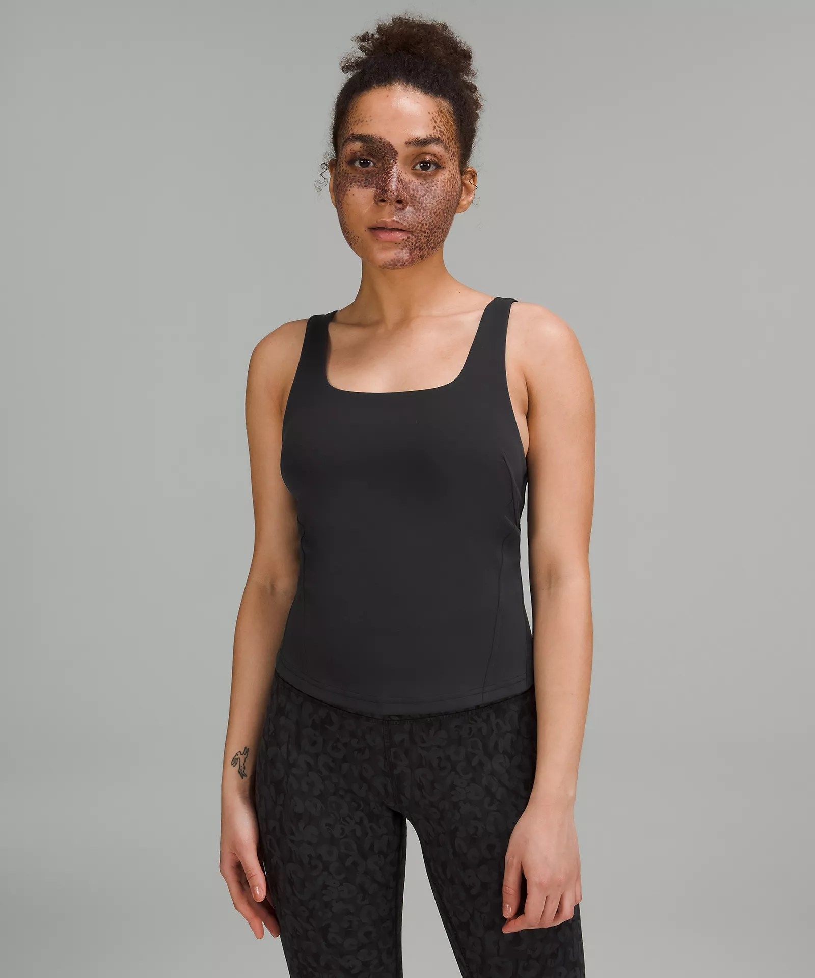 Model wearing black tank