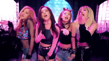 a K-pop group blowing kisses