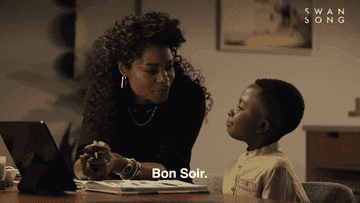 a woman saying to a boy, &quot;Bon soir&quot;