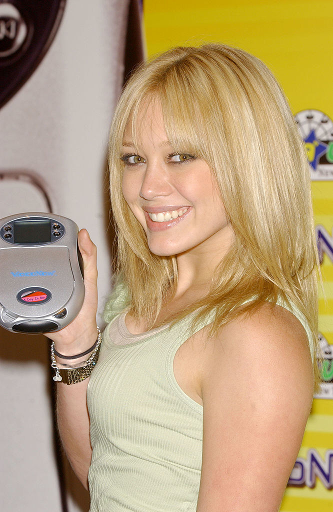 Hilary Duff holding a CD player