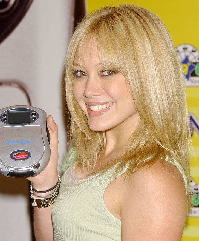 Hilary Duff holding a CD player