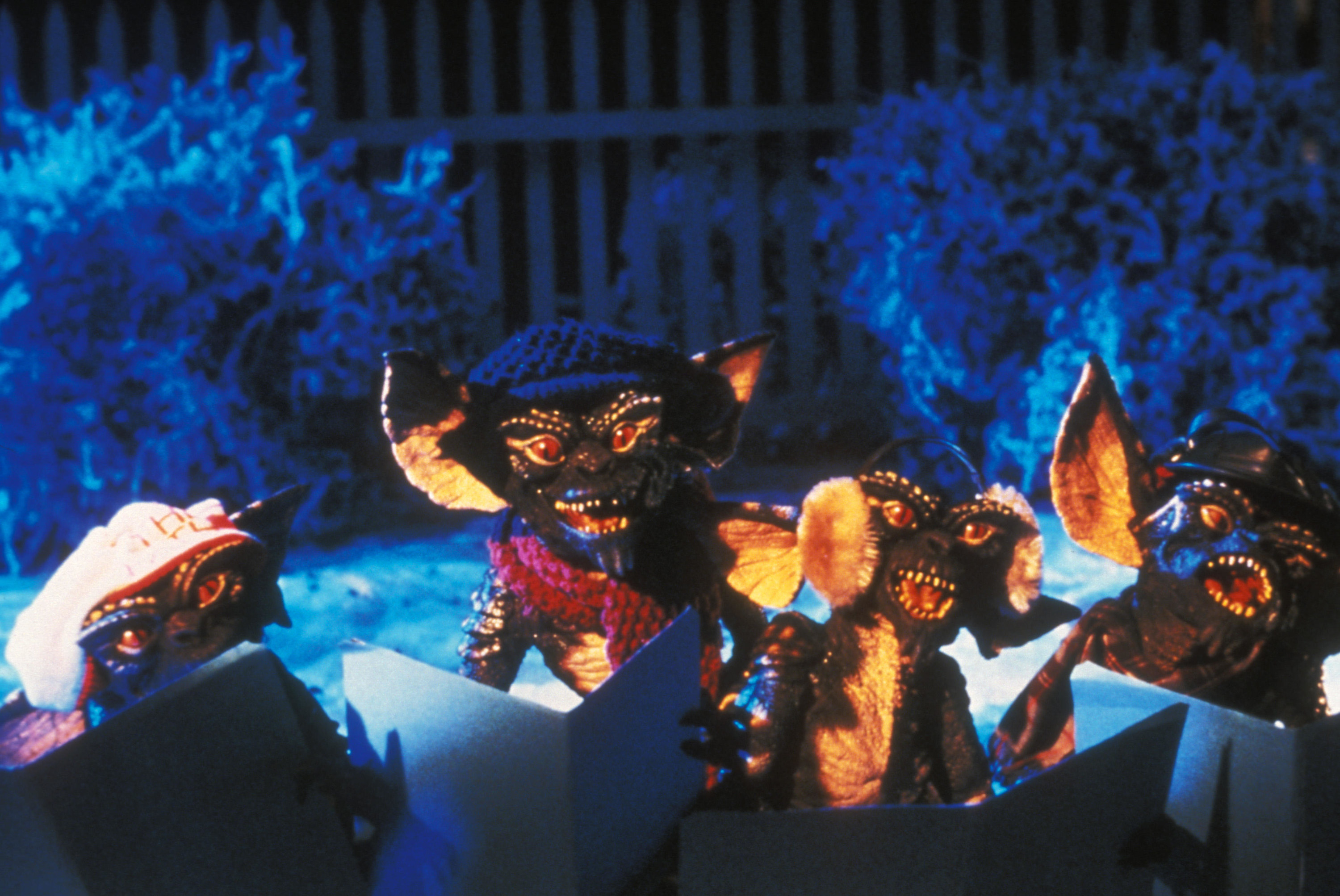 Four scaly gremlins sing Christmas Carols in the snow