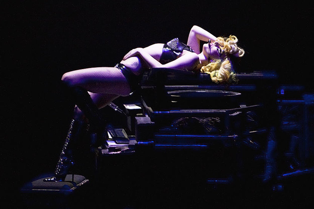Lady Gaga performs on stage lying on top of a piano during her Monster Ball Tour at O2 Arena on May 31, 2010 in London, England.