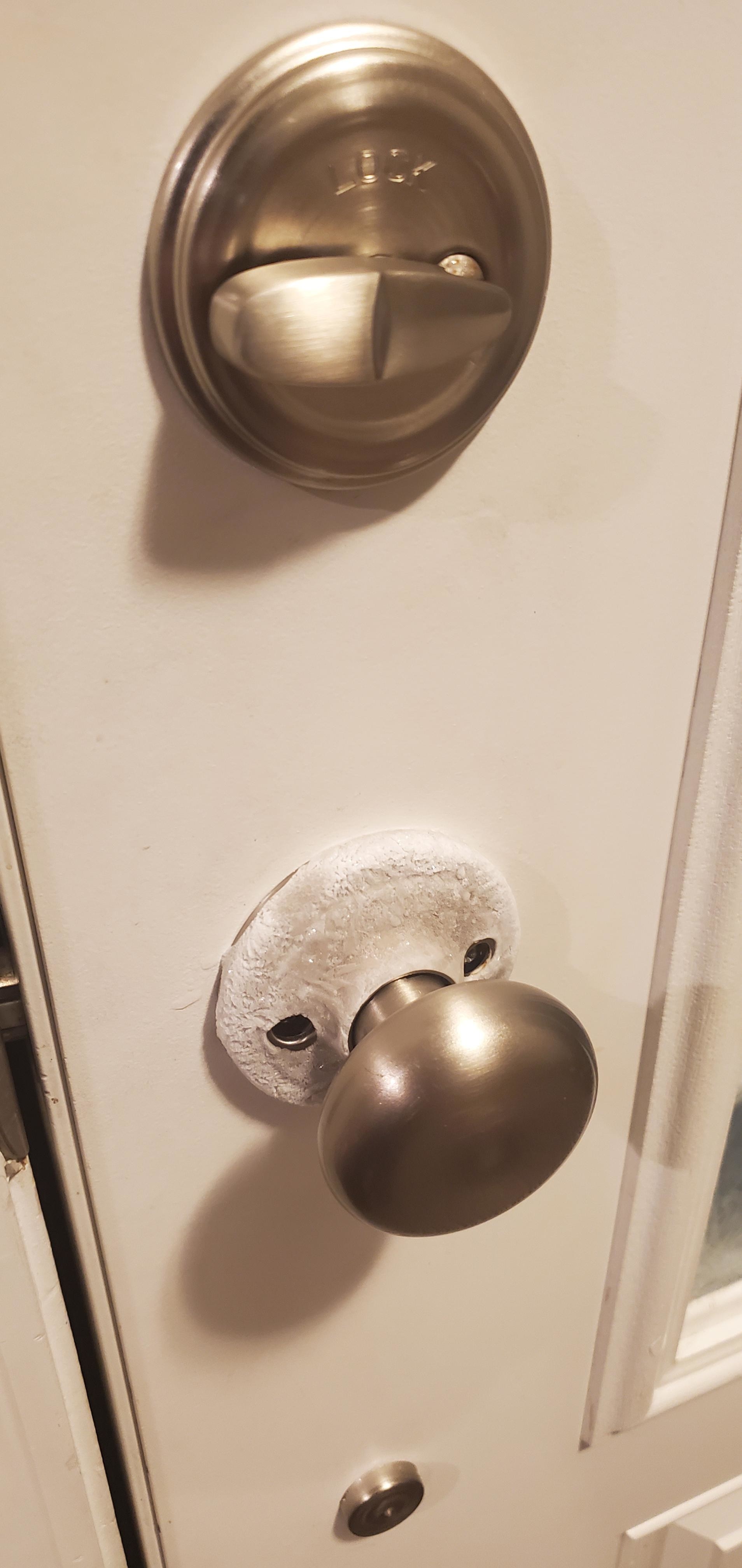 Close-up of doorknob with frost on it