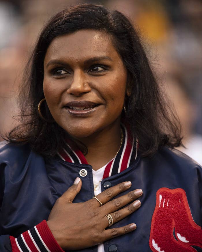 Close-up of Mindy with her hand resting on the front of her jacket