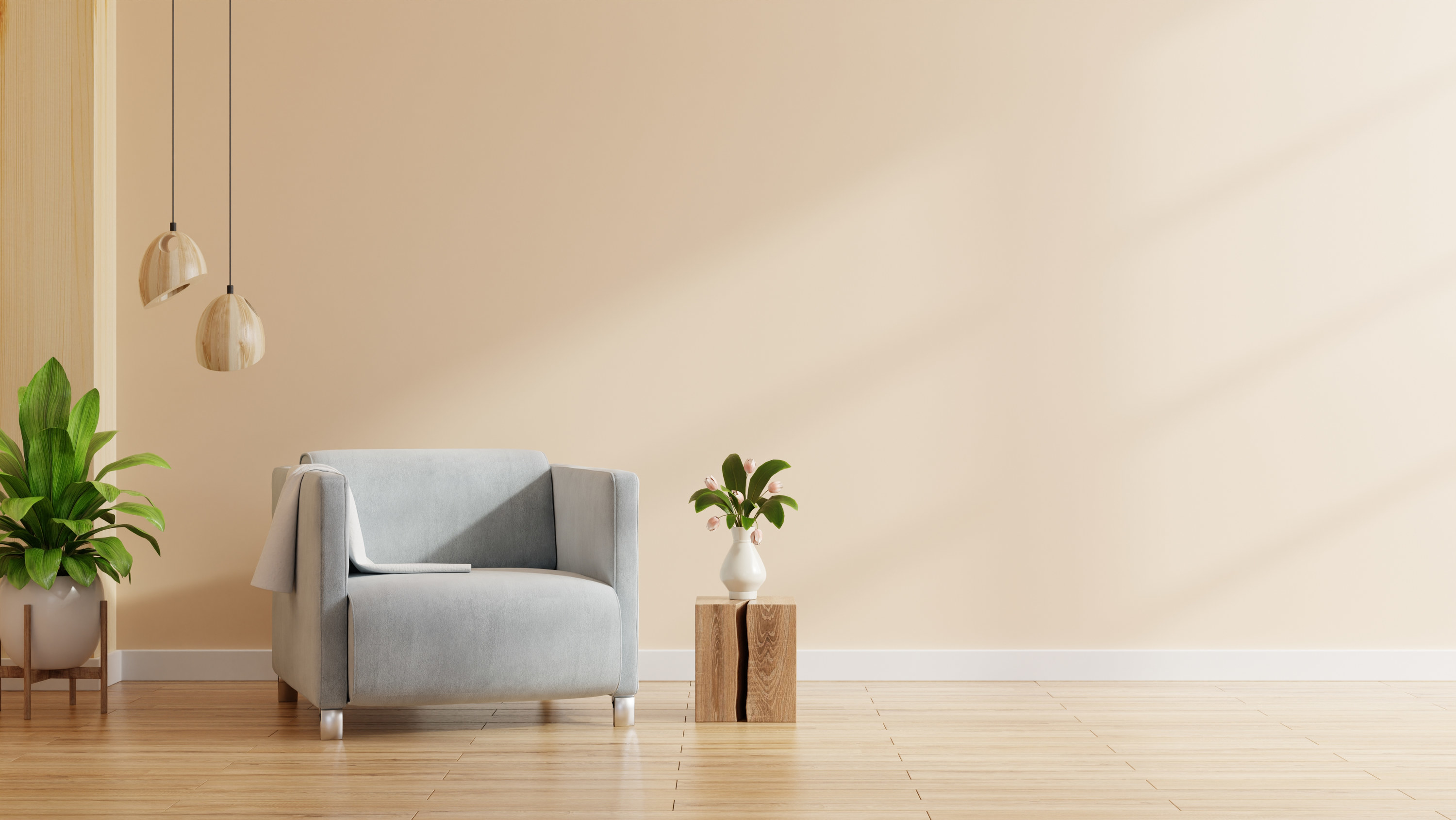 a very sparse minimalist living room with just a chair, a couple of plants, and a hanging lamp