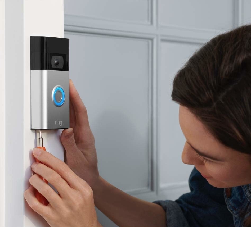 a person installing the doorbell to their home