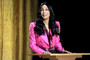 Cher speaks onstage during the Academy of Motion Picture Arts and Sciences