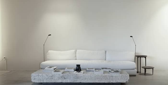 a minimalist room with a table and couch