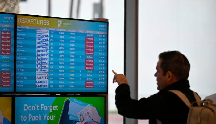 Person pointing at Departures notice