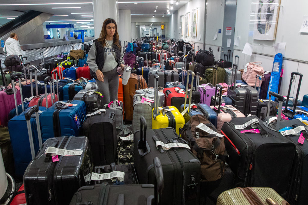 Person standing in a sea of luggage