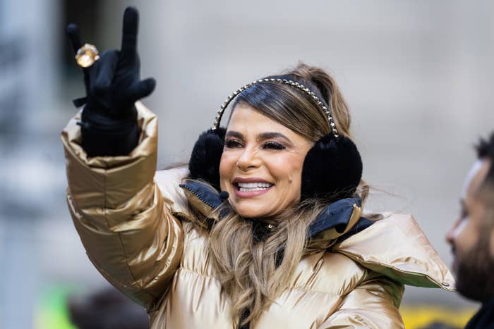 Paula in a coat and smiling and wearing ear muffs