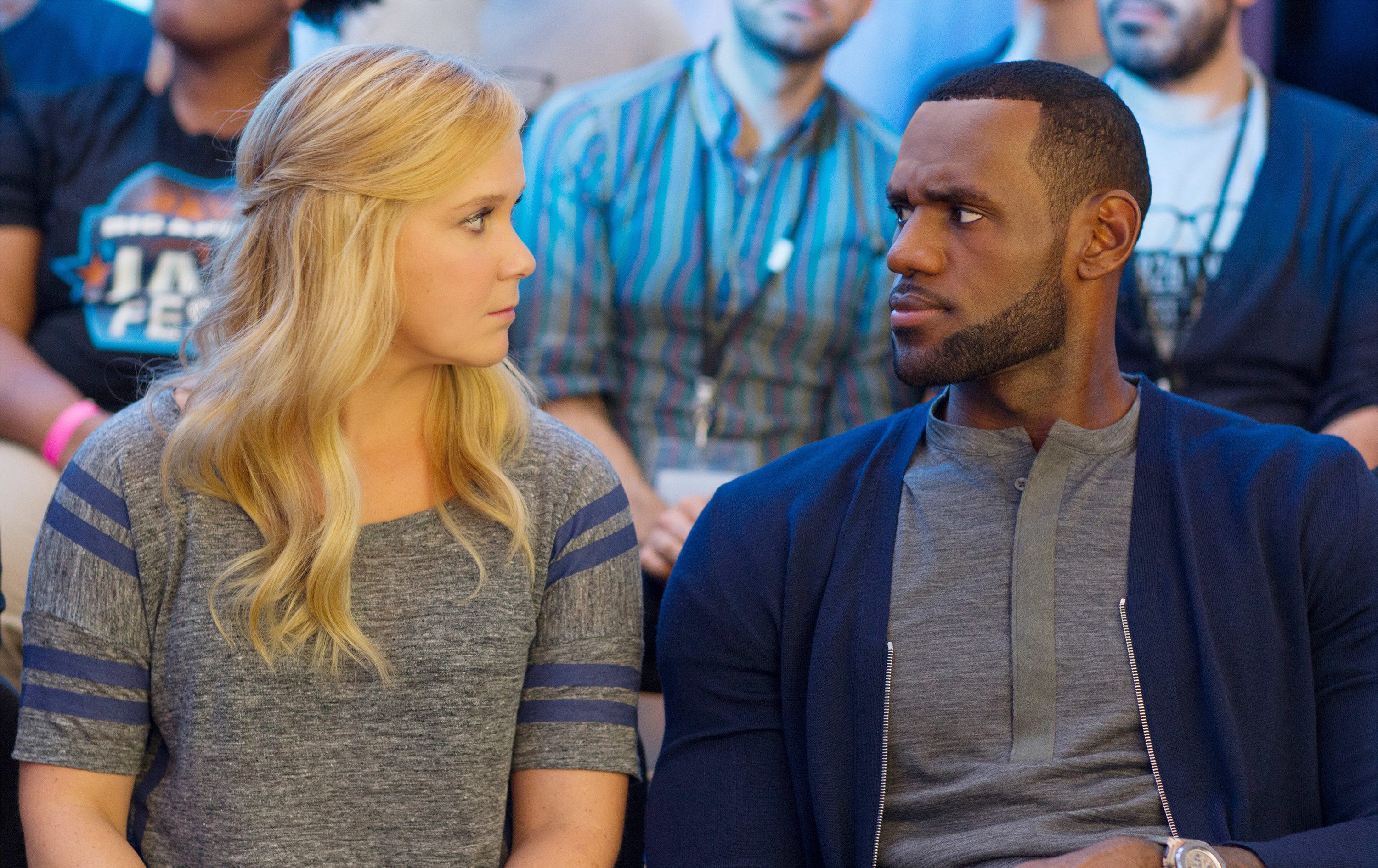 Amy Schumer sits beside LeBron James
