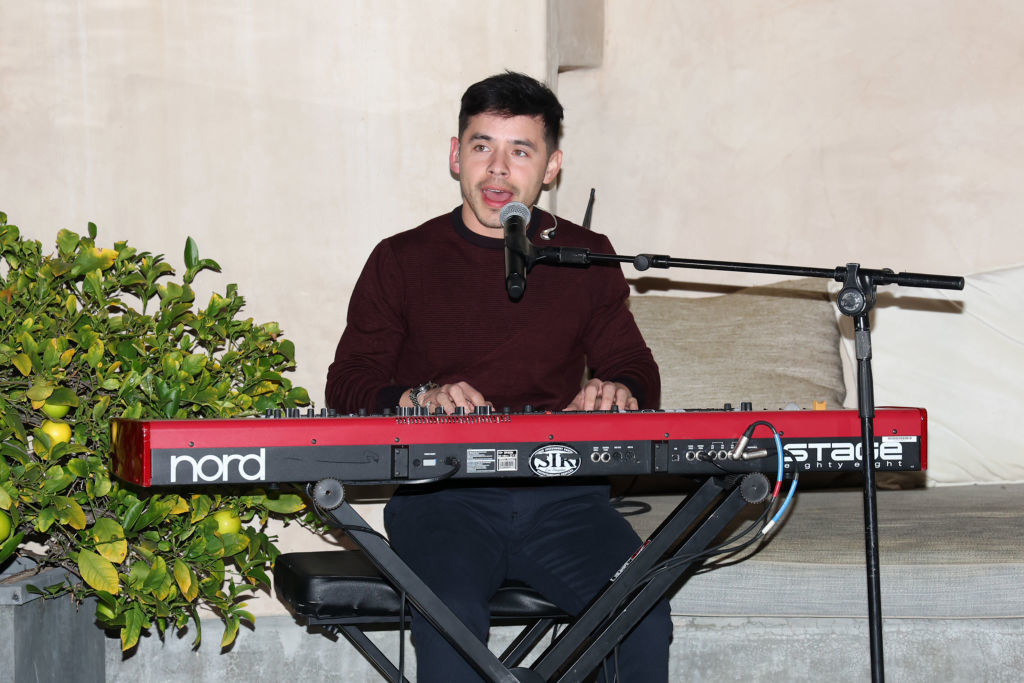 David singing while playing the keyboard